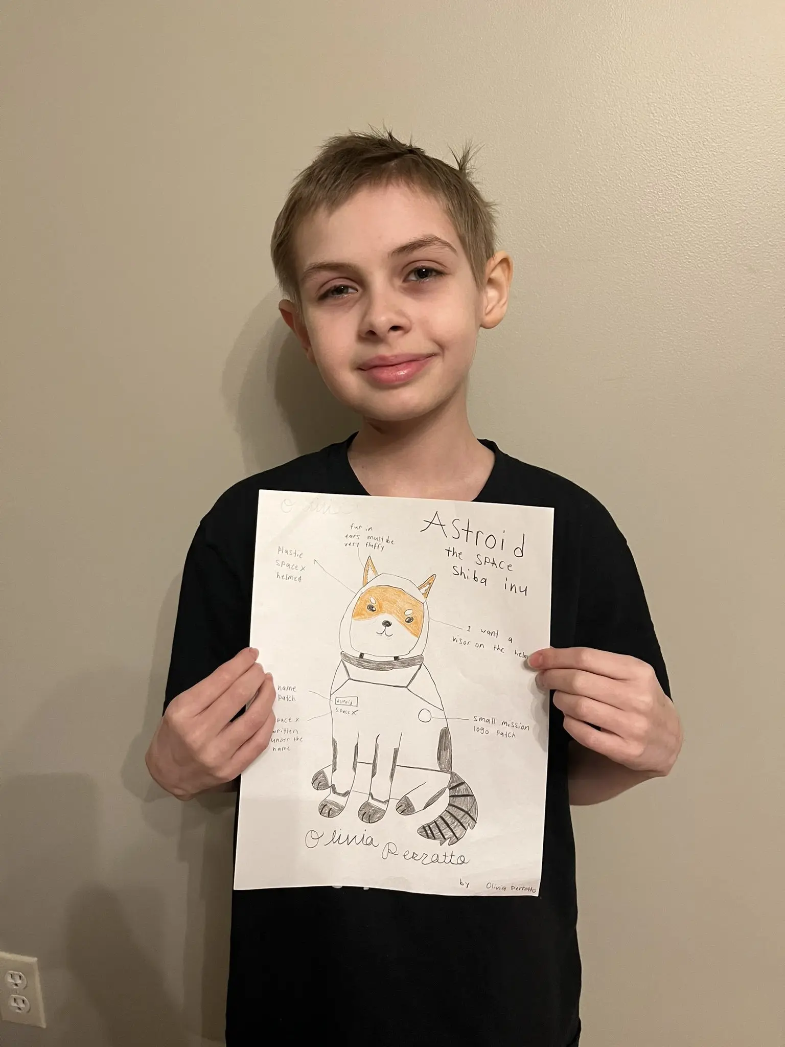 LIV during treatment, after losing her hair to radiation, holding the Asteroid Shiba Inu drawing